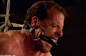 Three doms use and abuse Derek Pain during a live shoot.
