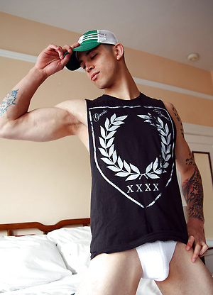 Tattooed stud shows his abs and fat cock