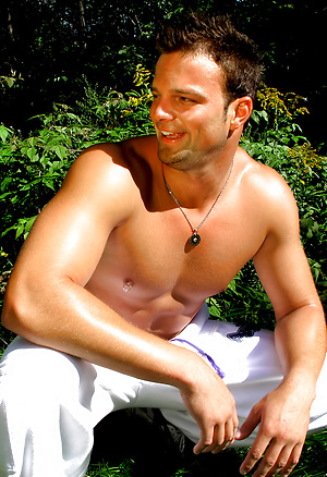 Ricky M's muscles glisten in the sun before he goes inside to play with his dick
