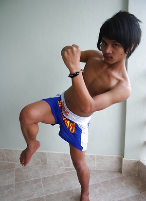 Cute gay Thai kickboxer posing and stripping