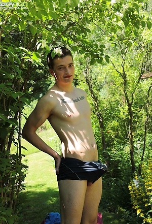 Tattooed Peter Jules masturbating outside in the yard.