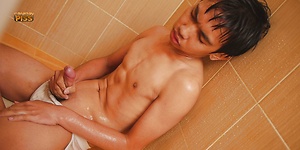 Cute youth pisses on himself in the sower before his friend shows up.