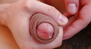 Sexy amateur wraps his cock head in his foreskin as he strokes and cums all over himself