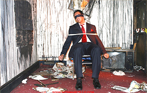 Marcello is tied up in a burnt out house by a masked man, who then apologises by licking his feet and sucking his big hard cock