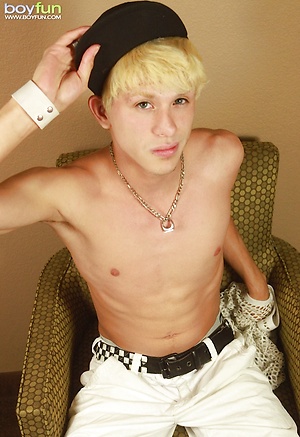Blond twink Angel Villanueva tugs on his thick cock.